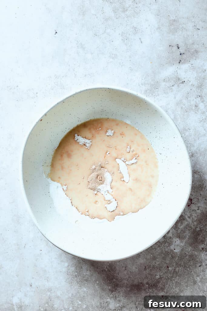 Yeast and other ingredients proofing in a bowl.