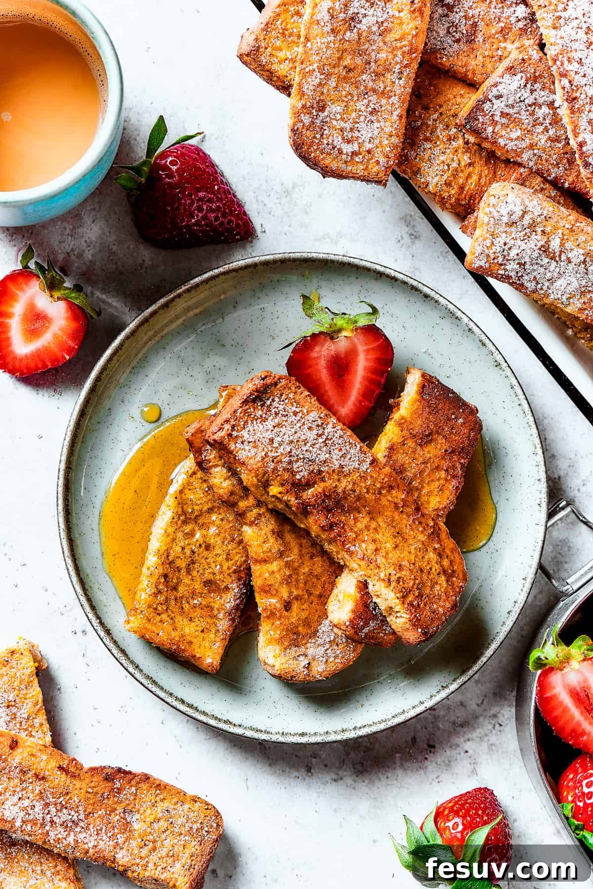 A strawberry-garnished plate of homemade French toast.