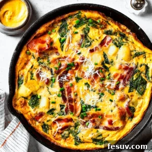 overhead shot of a fully-cooked frittata in a cast-iron skillet.