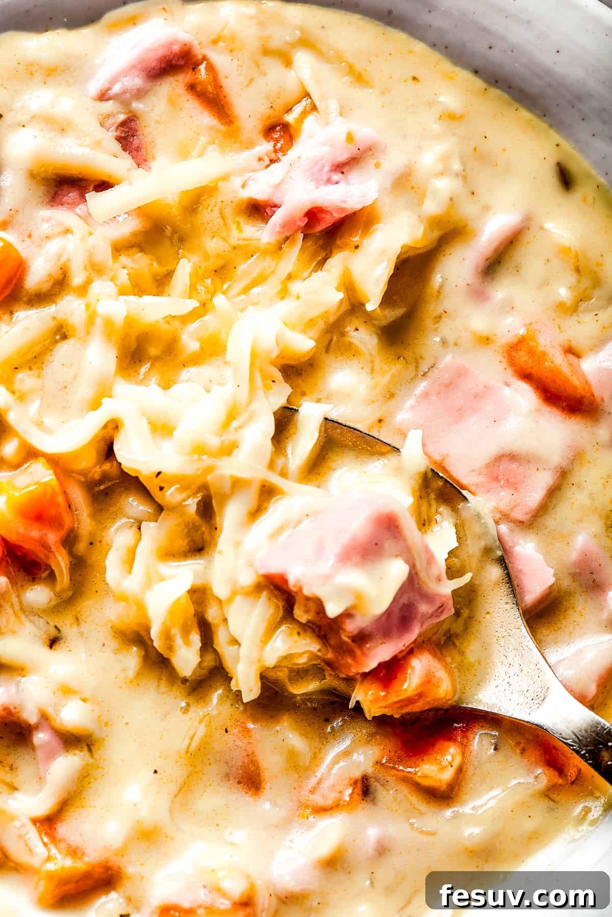Reuben Sandwich Soup 2 Close-up shot of Reuben soup with cheese and a spoon.