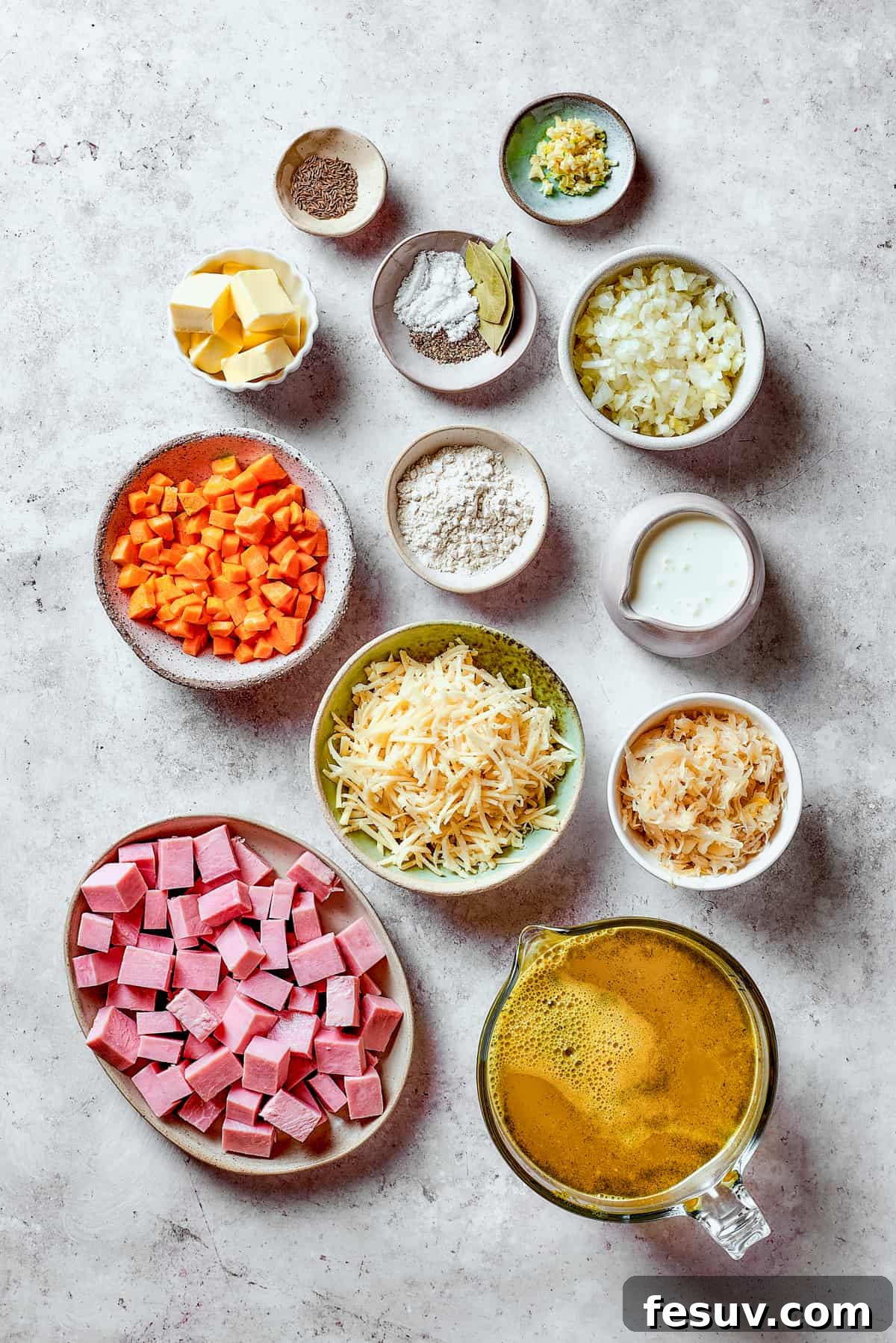This Creamy Reuben Soup takes corned beef, sauerkraut, and Swiss to a whole new level! It's a comfy, cozy masterpiece in a bowl. Ingredients for Reuben soup measured and arranged on a table.