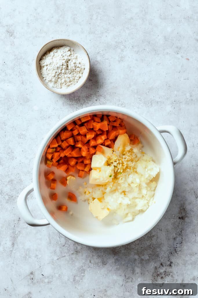 This Creamy Reuben Soup takes corned beef, sauerkraut, and Swiss to a whole new level! It's a comfy, cozy masterpiece in a bowl. Cooking vegetables with butter in a Dutch oven.