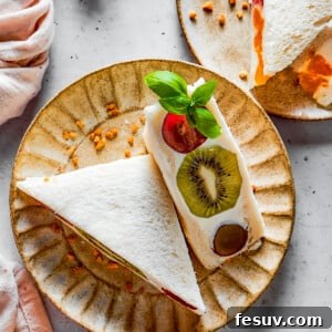 Overhead shot of fruit sandwich halves on a plate.