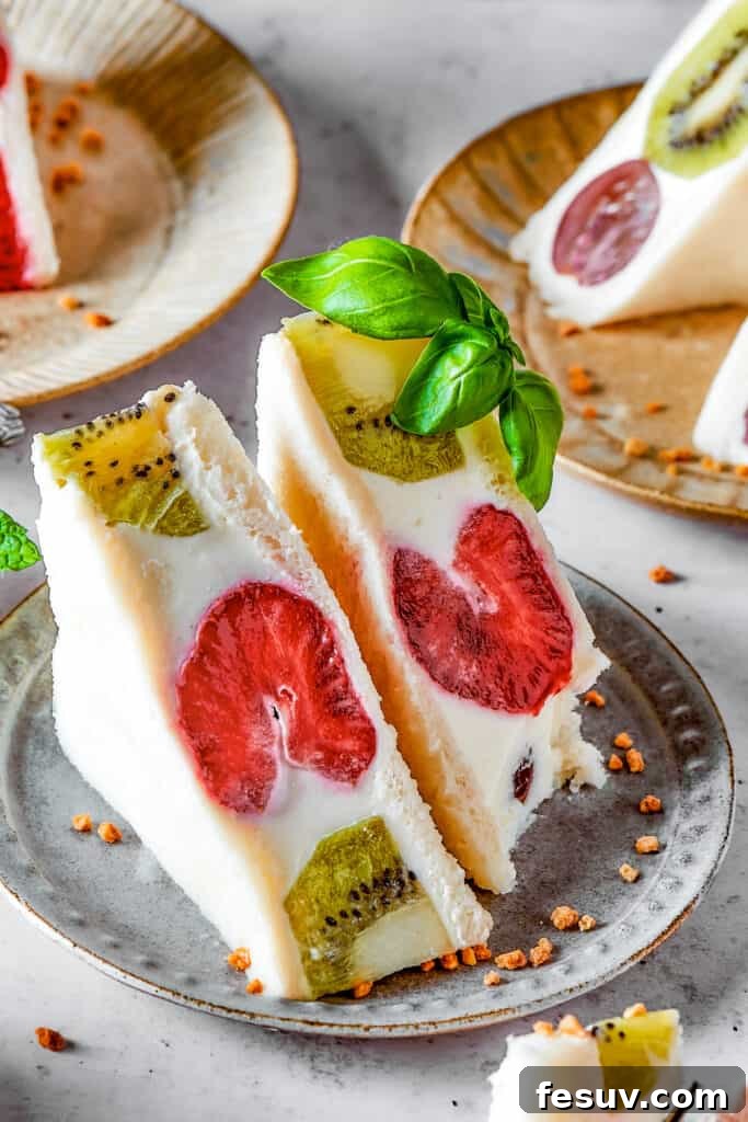 A perfectly sliced kiwi and strawberry fruit sando, showing the intricate fruit pattern.