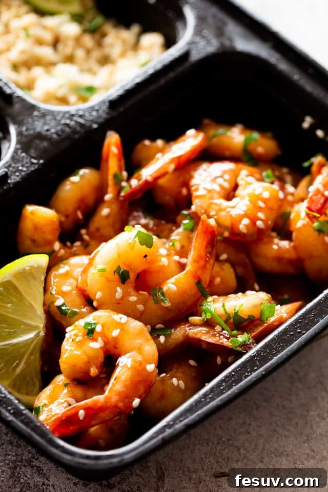 Enjoy a quick, flavorful meal with this sheet pan teriyaki shrimp stir fry, combining tangy sauce, crunchy veggies, and succulent shrimp. Sheet Pan Teriyaki Shrimp and vegetables in a black meal prep container.