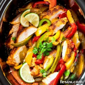 Crockpot chicken fajitas in a slow cooker insert.