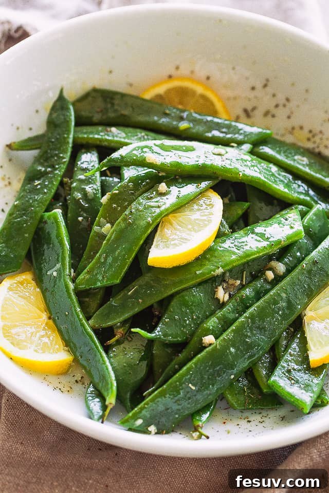 Romano Beans cooked in Garlic Butter are a delicious blend of healthy and tasty, easily prepared in no time! Garlic Butter Romano Beans served with fresh lemon slices, ready to be enjoyed.