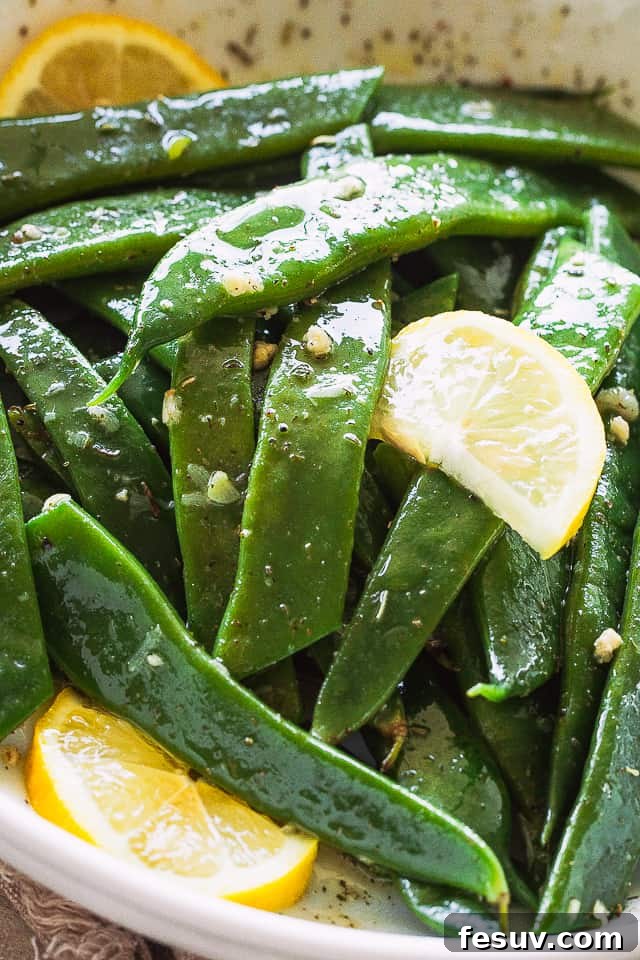 Romano Beans cooked in Garlic Butter are a delicious blend of healthy and tasty, easily prepared in no time! Close-up shot of blanched Romano Beans, showing their flat, wide shape.