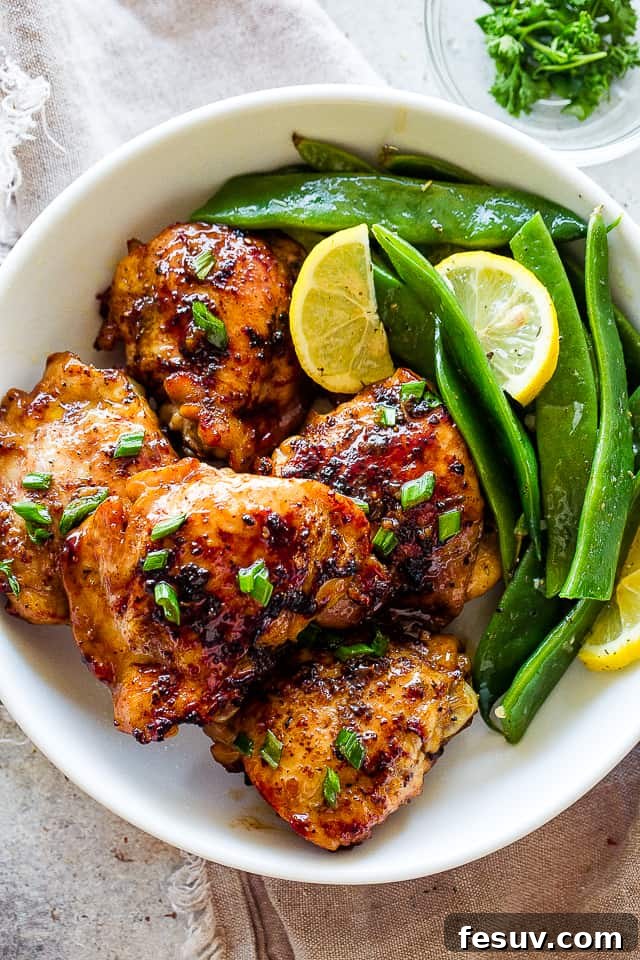 Romano Beans cooked in Garlic Butter are a delicious blend of healthy and tasty, easily prepared in no time! Romano flat beans served on a plate with browned chicken thighs and lemon.