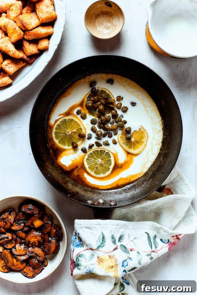 The delectable caper and lemon sauce taking shape. The creamy caper and lemon sauce simmering in the skillet, rich and inviting.