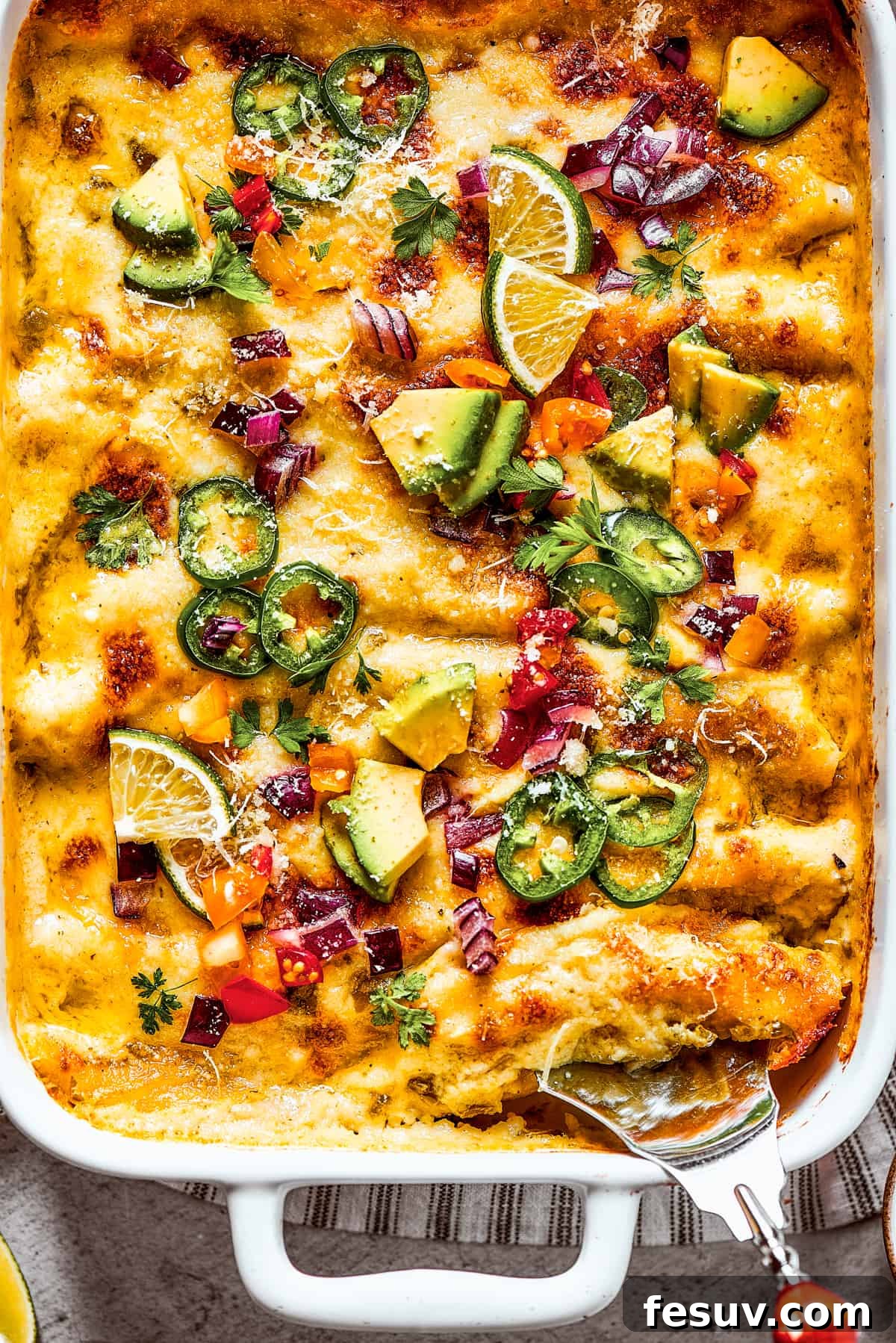Photo of the bottom corner of a baking dish of homemade shrimp enchiladas.