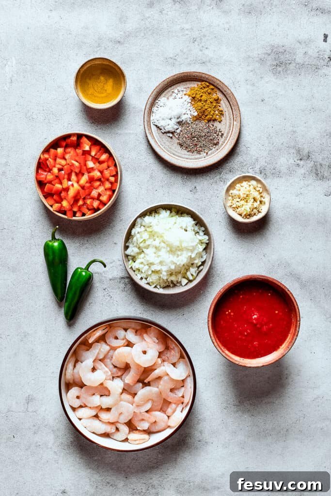 Ingredients for shrimp enchilada filling measured and arranged on a work surface.
