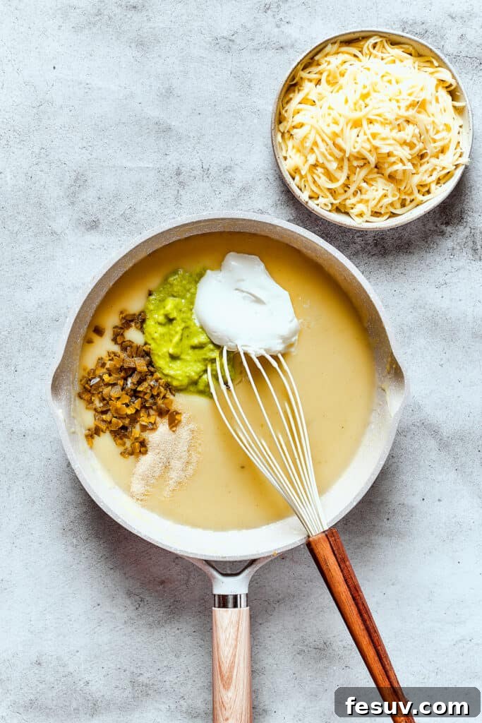 Making a creamy green enchilada sauce in a skillet.