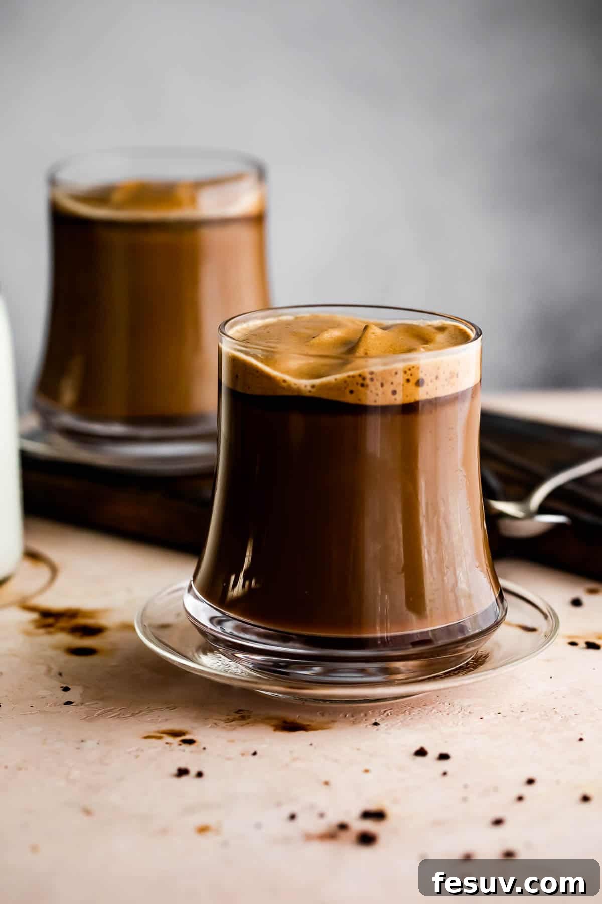 Two inviting glass mugs filled with Caffe Macchiato. Image of two glass coffee mugs filled with Caffe Macchiato.