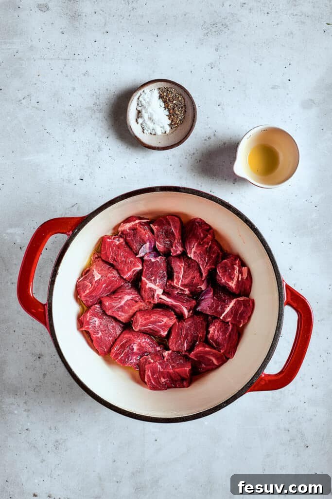 As the air gets crisper and the leaves turn golden, it's time to cozy up with a bowl of pure comfort - this old-fashioned Mulligan Stew! Browning beef in a soup pot.
