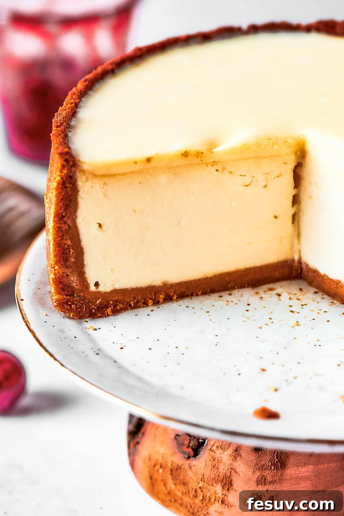 A close-up view of a perfectly sliced cherry cheesecake, showcasing its distinct layers and creamy texture.