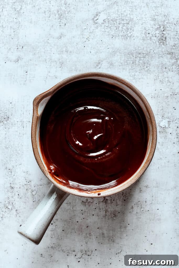 Overhead view of a saucepan full of chocolate ganache.