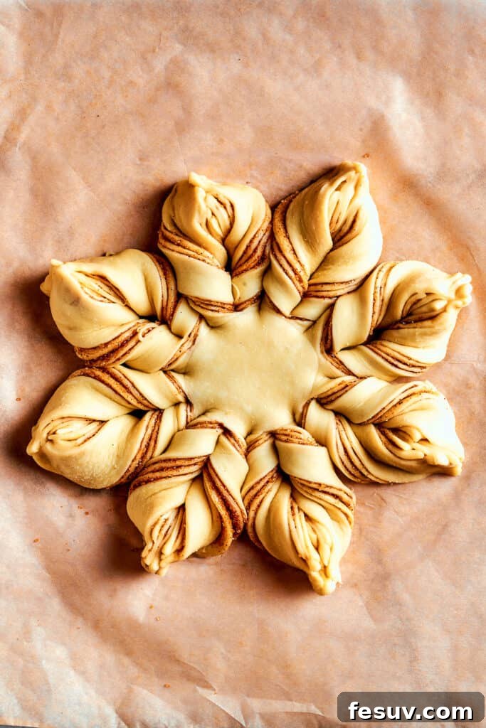 Overhead view of a fully assembled Star Bread, beautifully twisted into its iconic star shape, ready for its final proofing before baking.