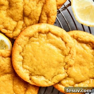 Close-up shot of several lemon cookies arranged on a round wire rack.