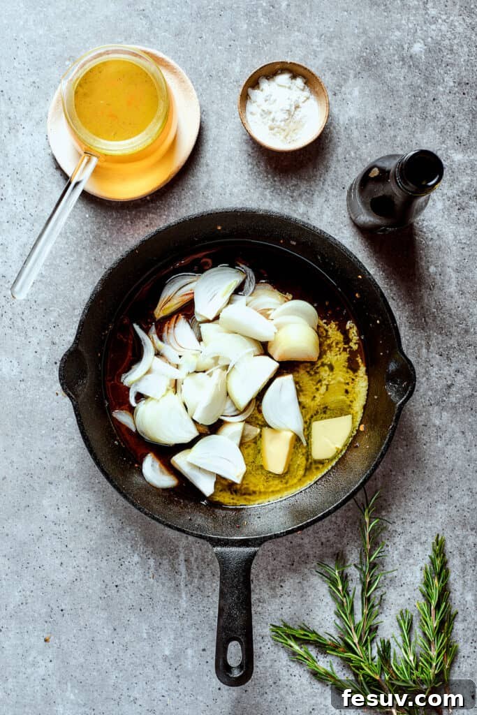 Sautéing Onions for Gravy Thinly sliced yellow onions sizzling in melted butter in a hot cast iron skillet.