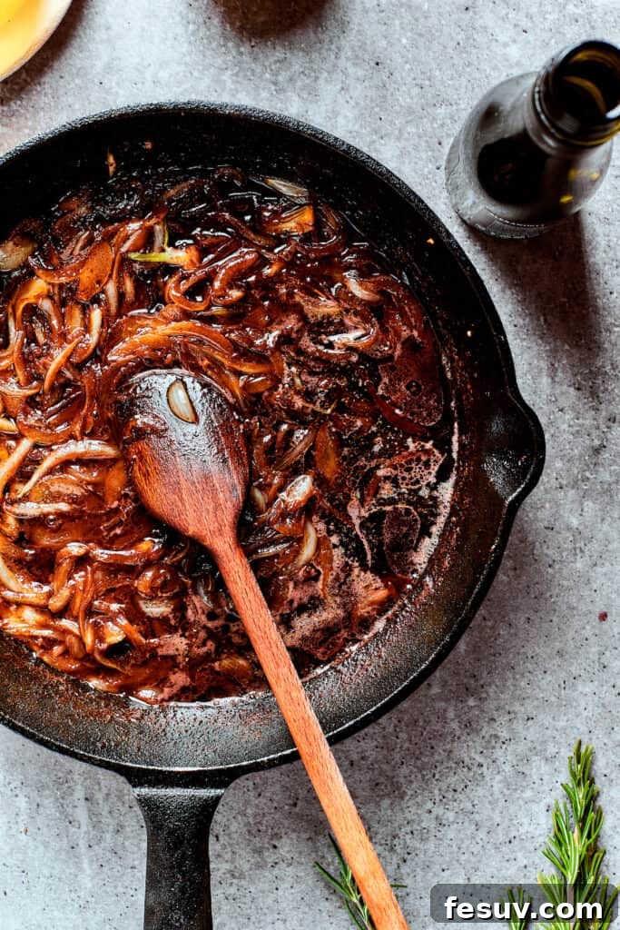 Caramelized Onions for Rich Gravy Deep golden-brown caramelized onions in a skillet, providing a rich flavor base for the gravy.