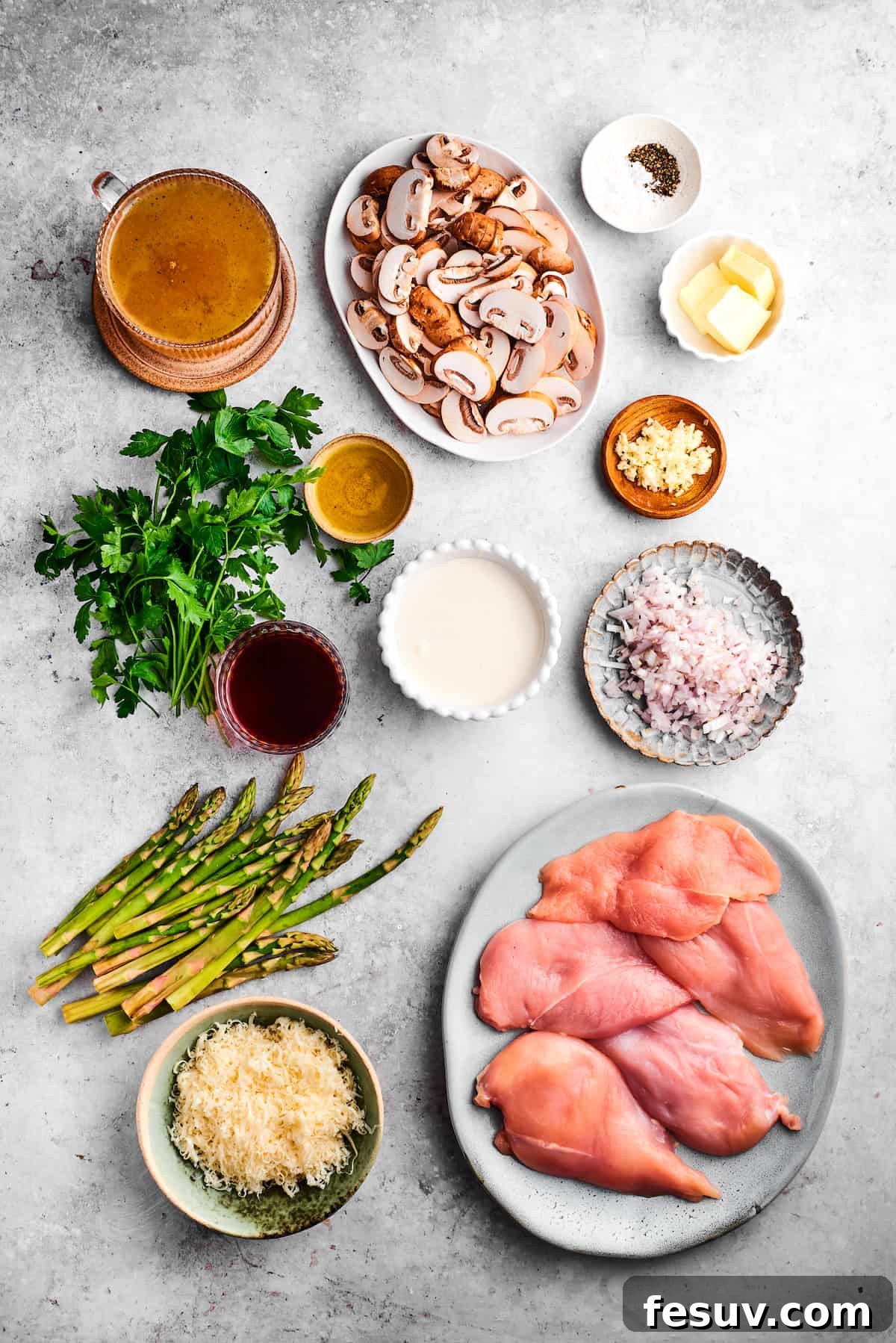 Key ingredients for Chicken Madeira: fresh, high-quality components for an unforgettable meal. A beautiful flat lay of all the fresh ingredients needed for Chicken Madeira, including chicken breasts, various mushrooms, green asparagus, fresh parsley, salt, pepper, butter, olive oil, Madeira wine, garlic, mozzarella, cream, and broth.