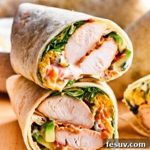 Spicy Buffalo Chicken Wrap 2 A cut buffalo chicken wrap shows the interior of chicken and vegetables.