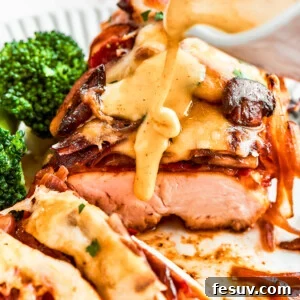 A thick stream of vivid yellow honey mustard sauce is added to a plate of Alice Springs chicken.