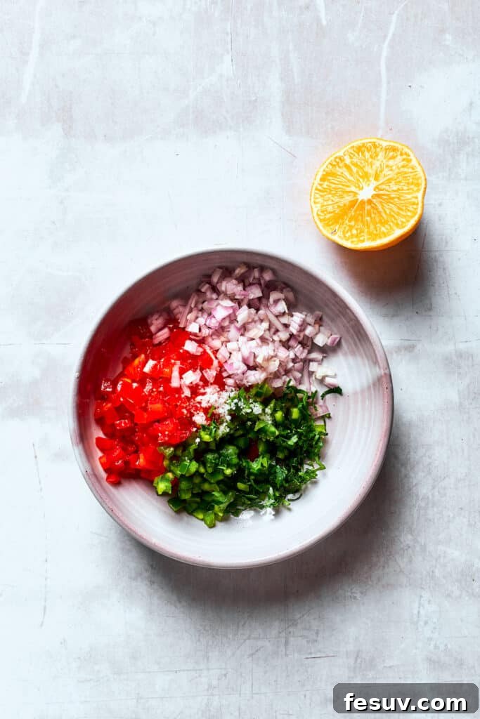 Pico de gallo ingredients are placed in a white bowl.