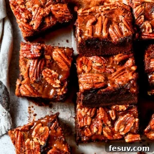Pecan Pie Brownies lined on parchment paper.