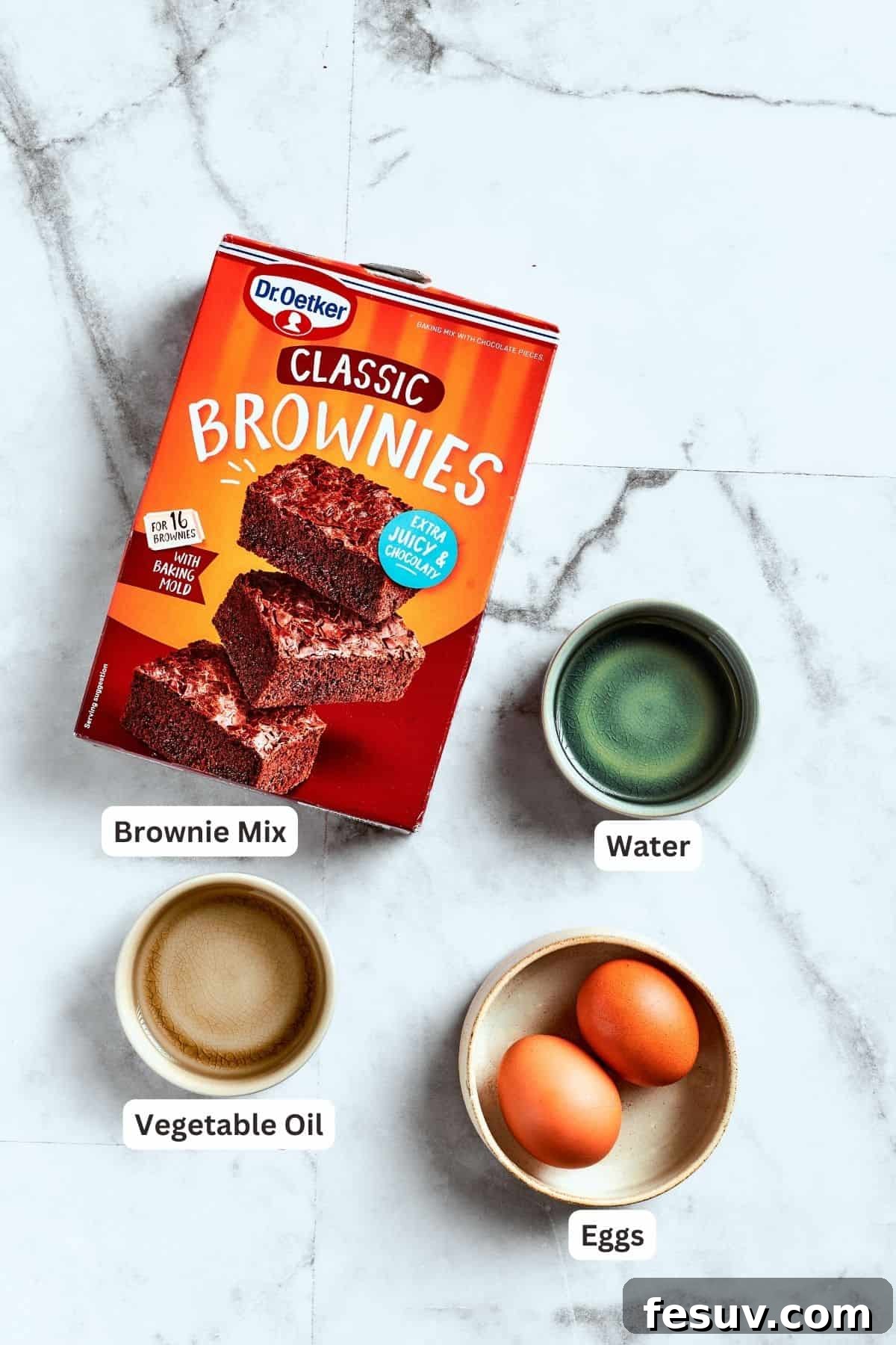 Brownie base ingredients laid out for easy reference. The essential ingredients for making the brownie base: boxed brownie mix, eggs, water, and oil.