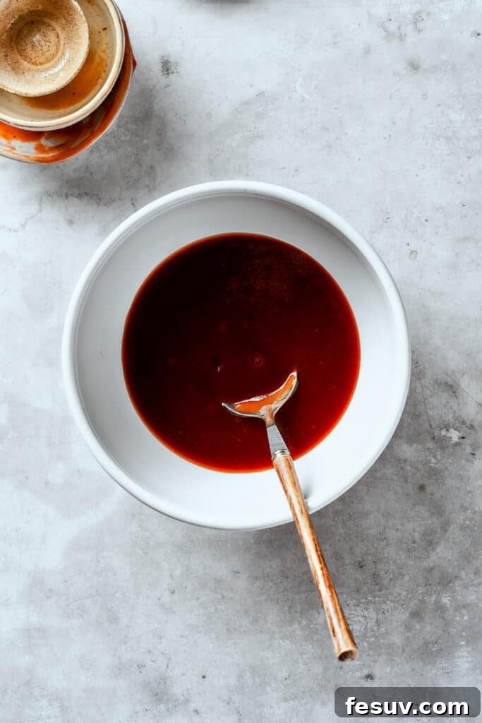 Mixing the ingredients for Tonkatsu sauce in a bowl.
