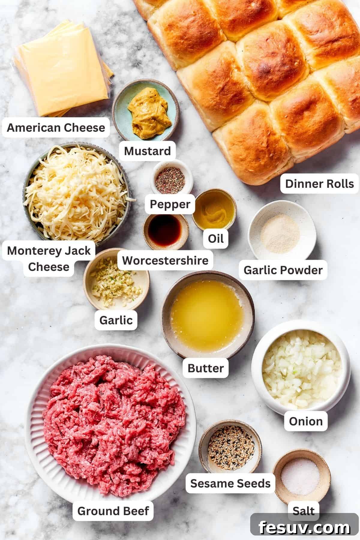 The ingredients for cheeseburger sliders are displayed and labeled: dinner rolls, ground beef, American cheese, Monterey Jack cheese, Worcestershire sauce, garlic powder, olive oil, butter, onion, garlic, mustard, salt, and pepper.
