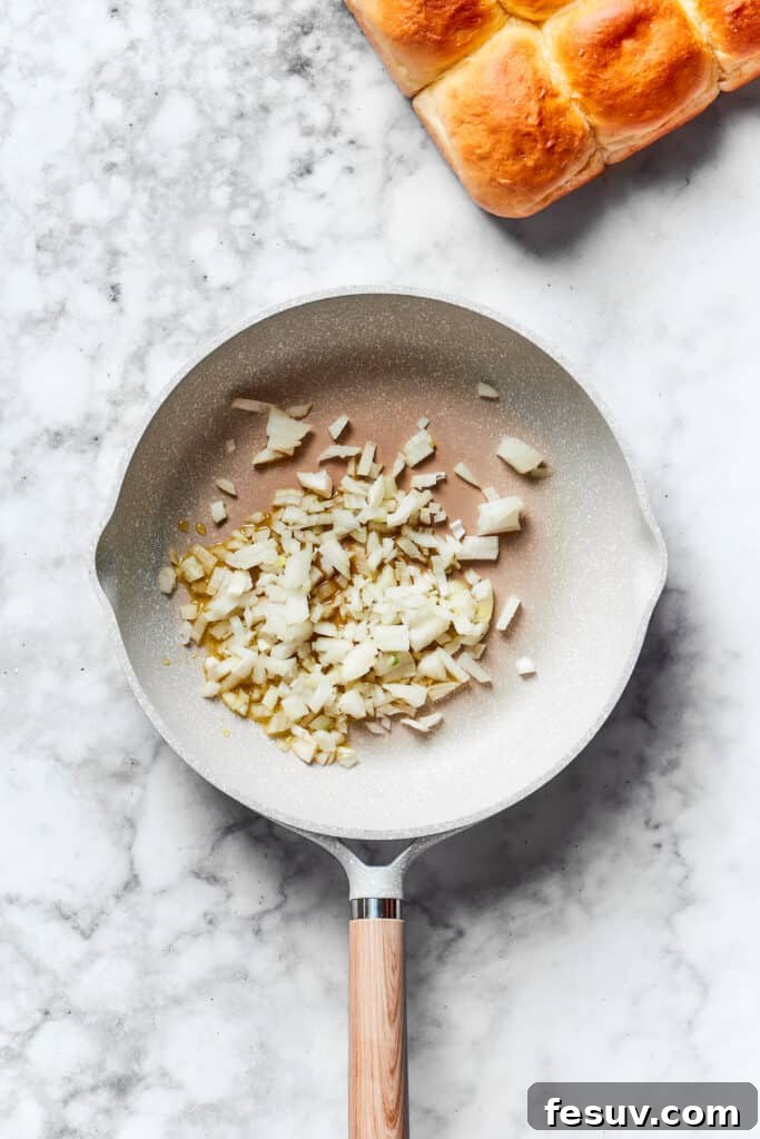 Finely chopped onion cooking in a hot skillet with olive oil until translucent.