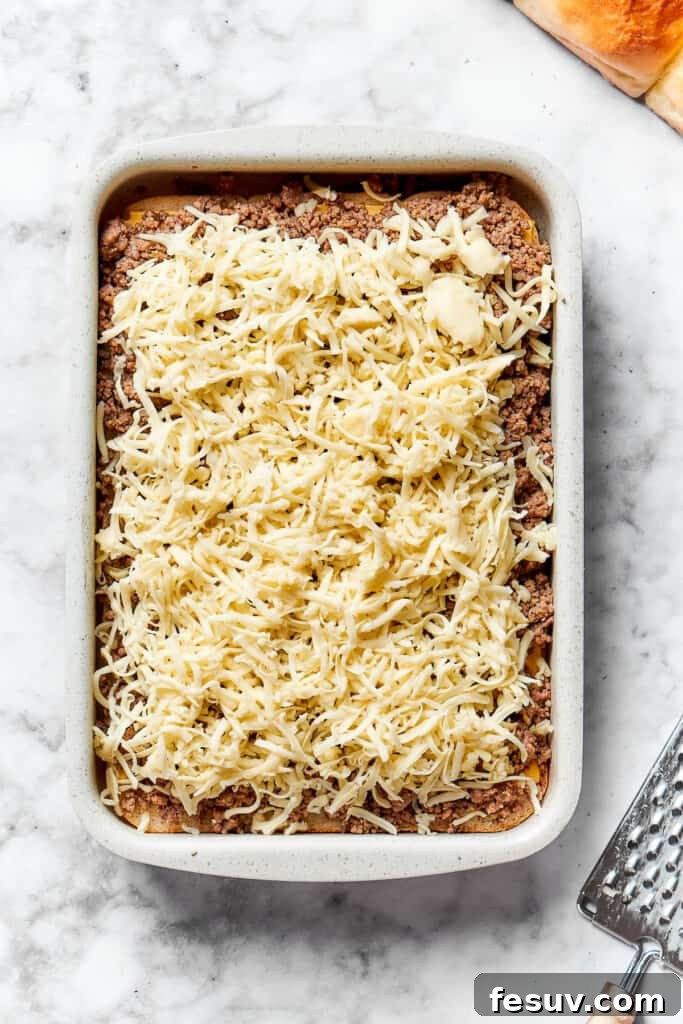 Shredded Monterey Jack cheese generously sprinkled over the ground beef layer.