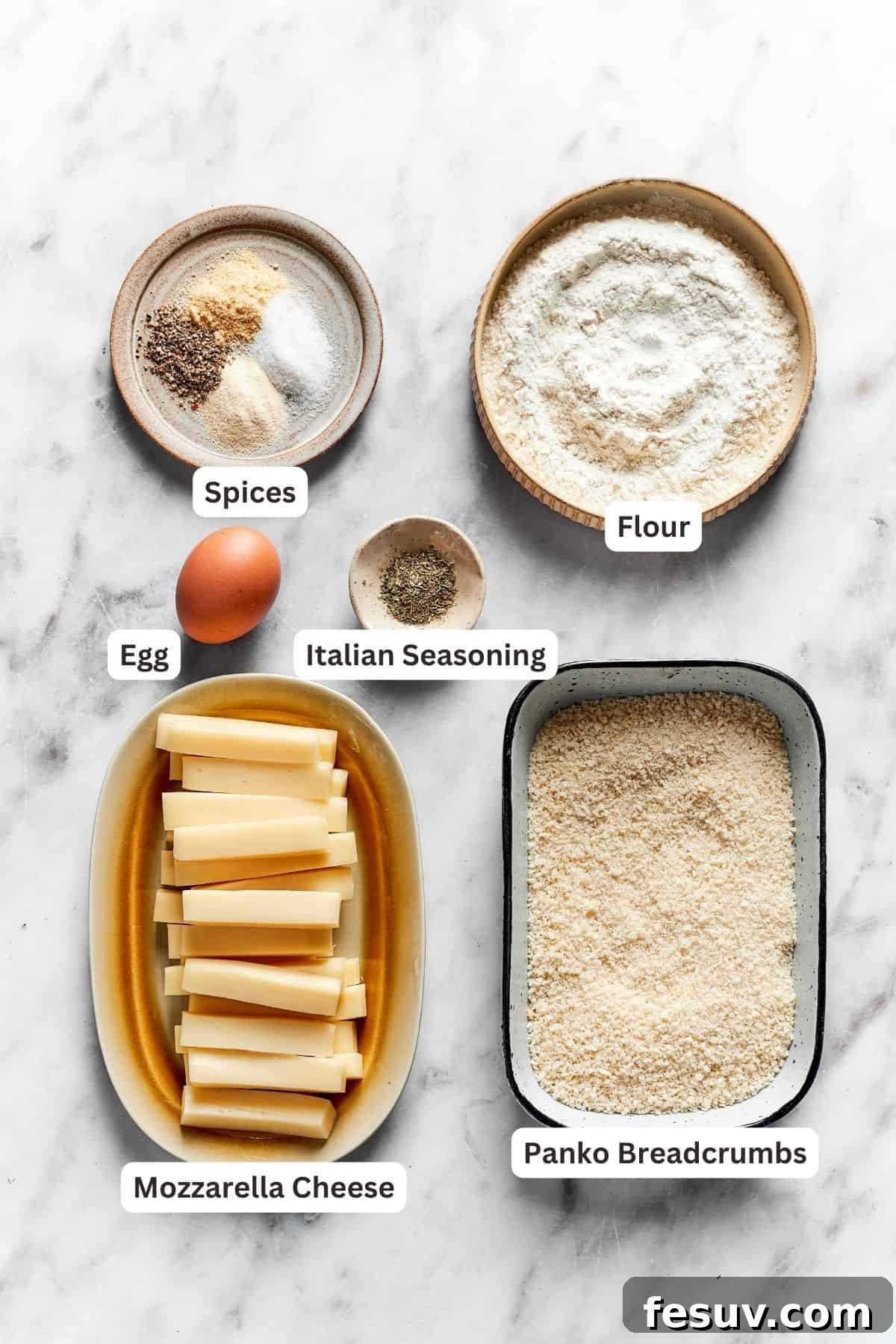 All the essential ingredients for homemade mozzarella sticks are neatly portioned and labeled on a wooden board: mozzarella cheese sticks, panko breadcrumbs, all-purpose flour, a beaten egg, Italian seasoning, salt, and pepper.