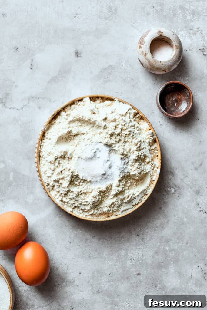 Chewy, buttery White Chocolate Chip Cookies are packed with creamy, sweet white chocolate chips instead of semisweet for an unexpected twist. A generous amount of all-purpose flour, a pinch of salt, and baking soda are carefully measured and added into a medium-sized mixing bowl, ready to be whisked together for the dry mix of the white chocolate chip cookie dough.