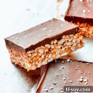 Chewy Peanut Butter Crunch Squares 2 A square bar of peanut butter rice krispies topped with a smooth layer of melted chocolate.