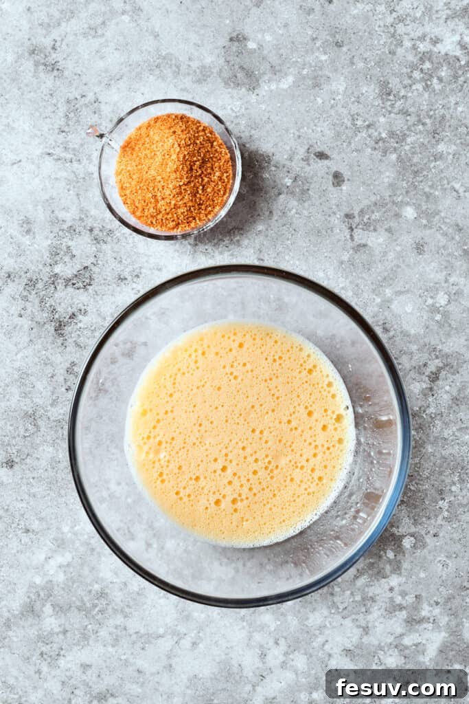 Creamy mixture of butter and sour cream being mixed in a bowl, a key step for moist banana bread.