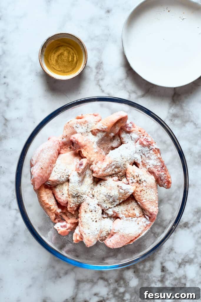 This easy Buffalo Wings recipe soaks crisp fried wings in a homemade buffalo sauce that's loaded with hot sauce and honey for intense flavor. The chicken is mixed with flour.