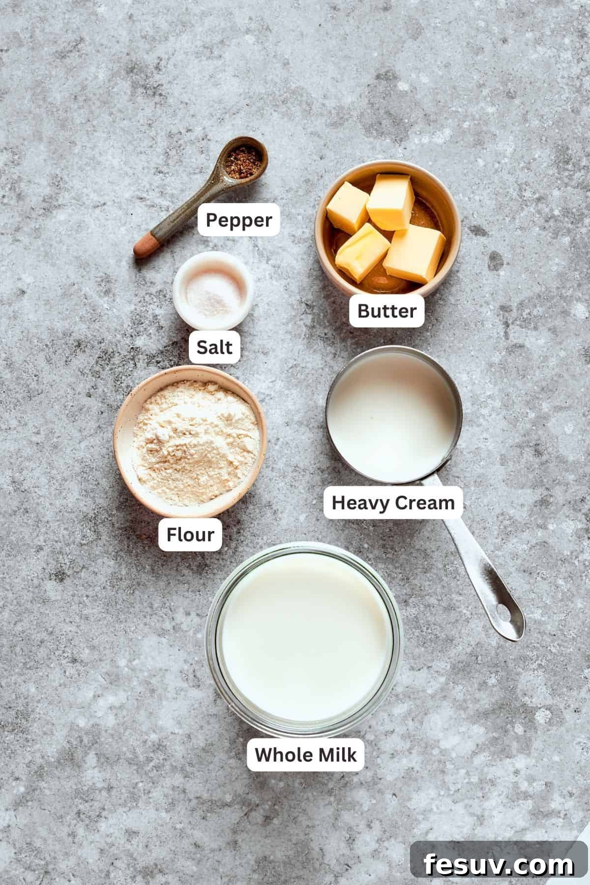 Key ingredients for the irresistible gravy. Ingredients for creamy gravy, including flour, heavy cream, milk, butter, salt and pepper.