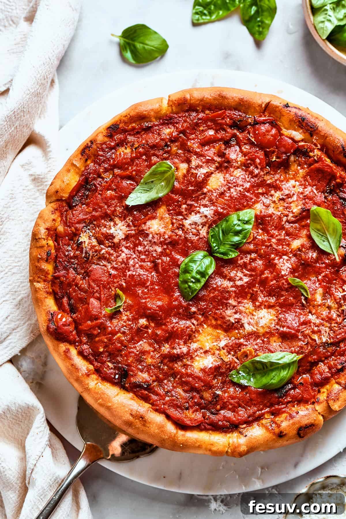 A perfectly baked Deep Dish Pizza, featuring a vibrant tomato sauce and fresh basil. Another beautiful overhead shot of a freshly baked deep dish pizza, garnished with vibrant fresh basil leaves, ready to be devoured by hungry guests.