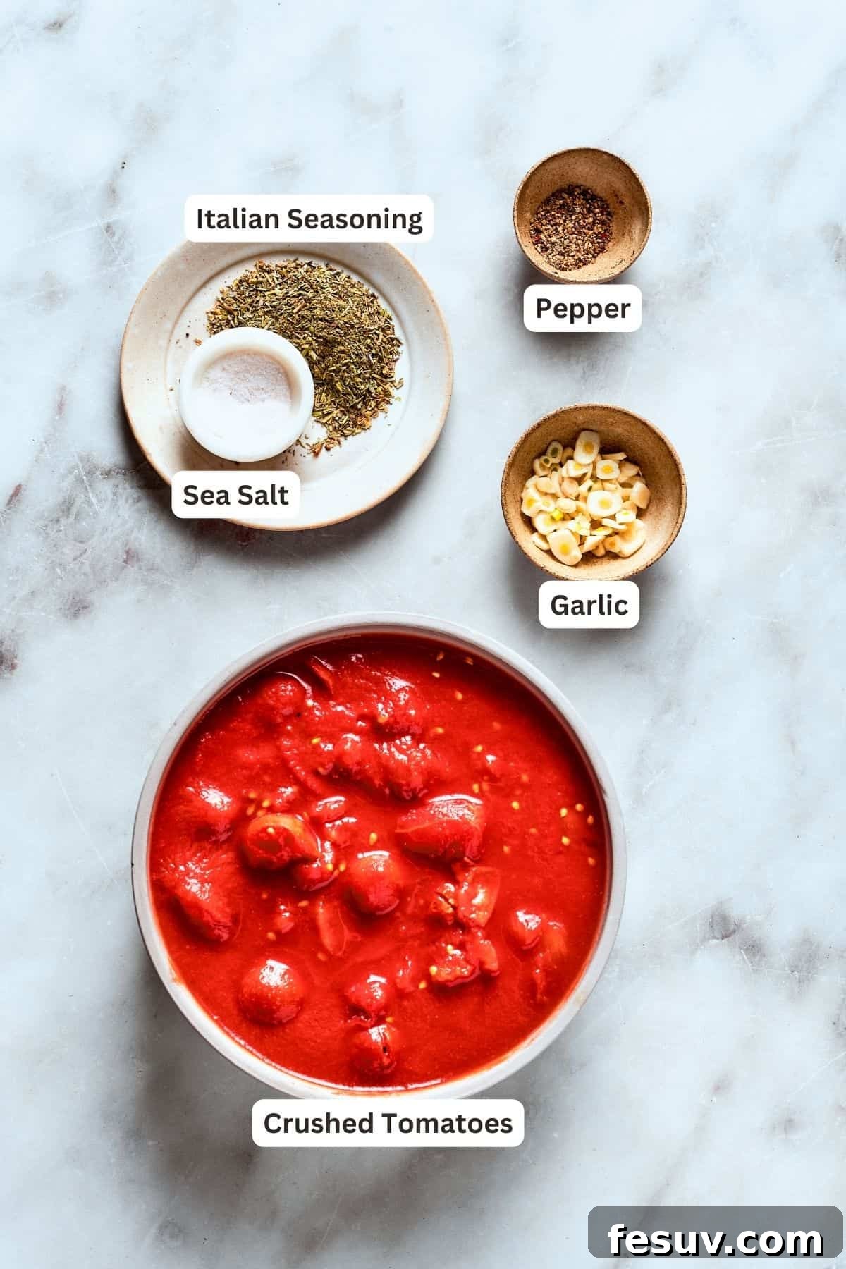The components for our robust and thick deep dish pizza sauce. Ingredients for deep dish pizza sauce: a can of crushed tomatoes, fresh garlic cloves, black pepper, Italian seasoning, and sea salt.