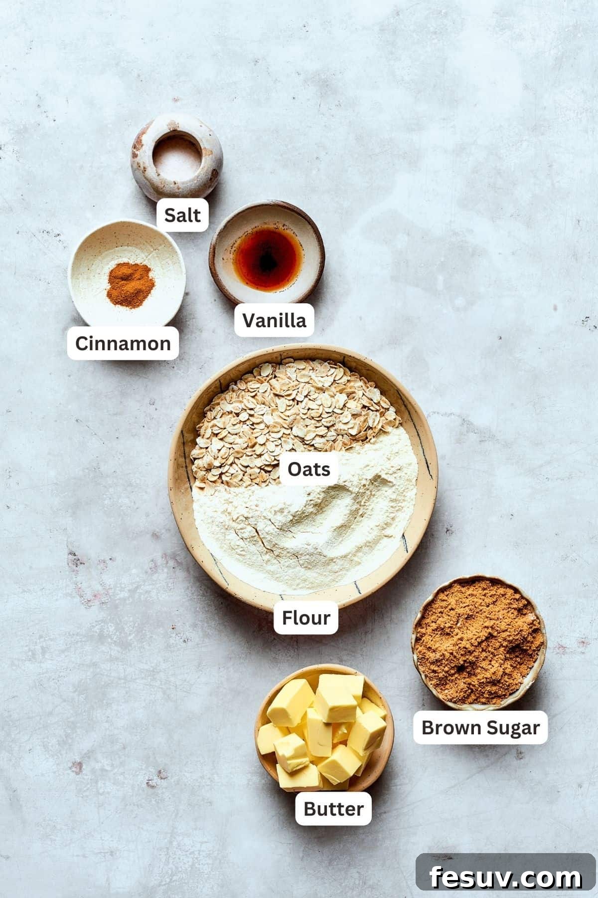 Ingredients for the crisp topping, ready to be combined Labeled ingredients for the crisp topping: cinnamon, vanilla extract, salt, all-purpose flour, old-fashioned oats, cold unsalted butter, and light brown sugar.