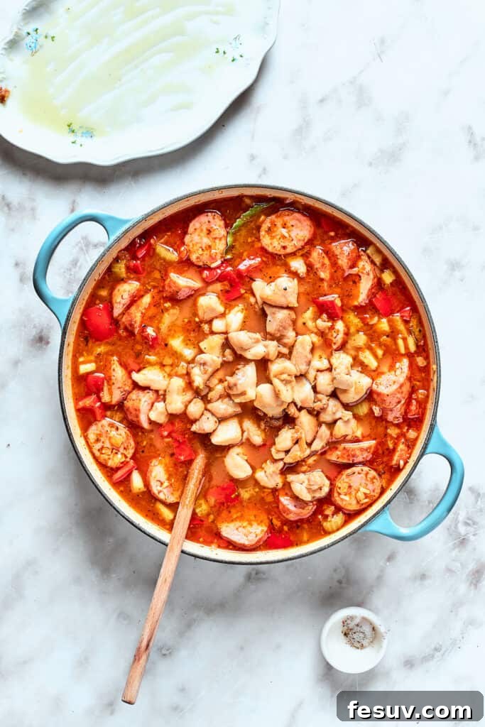 Chicken is stirred back into the jambalaya.
