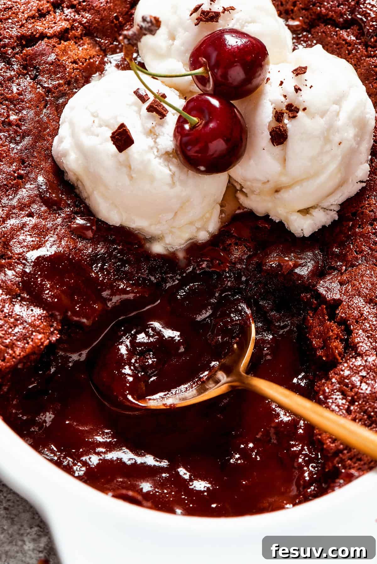 Heavenly Chocolate Pudding Cake 15 Close-up image of a spoon stirring through chocolate pudding cake.