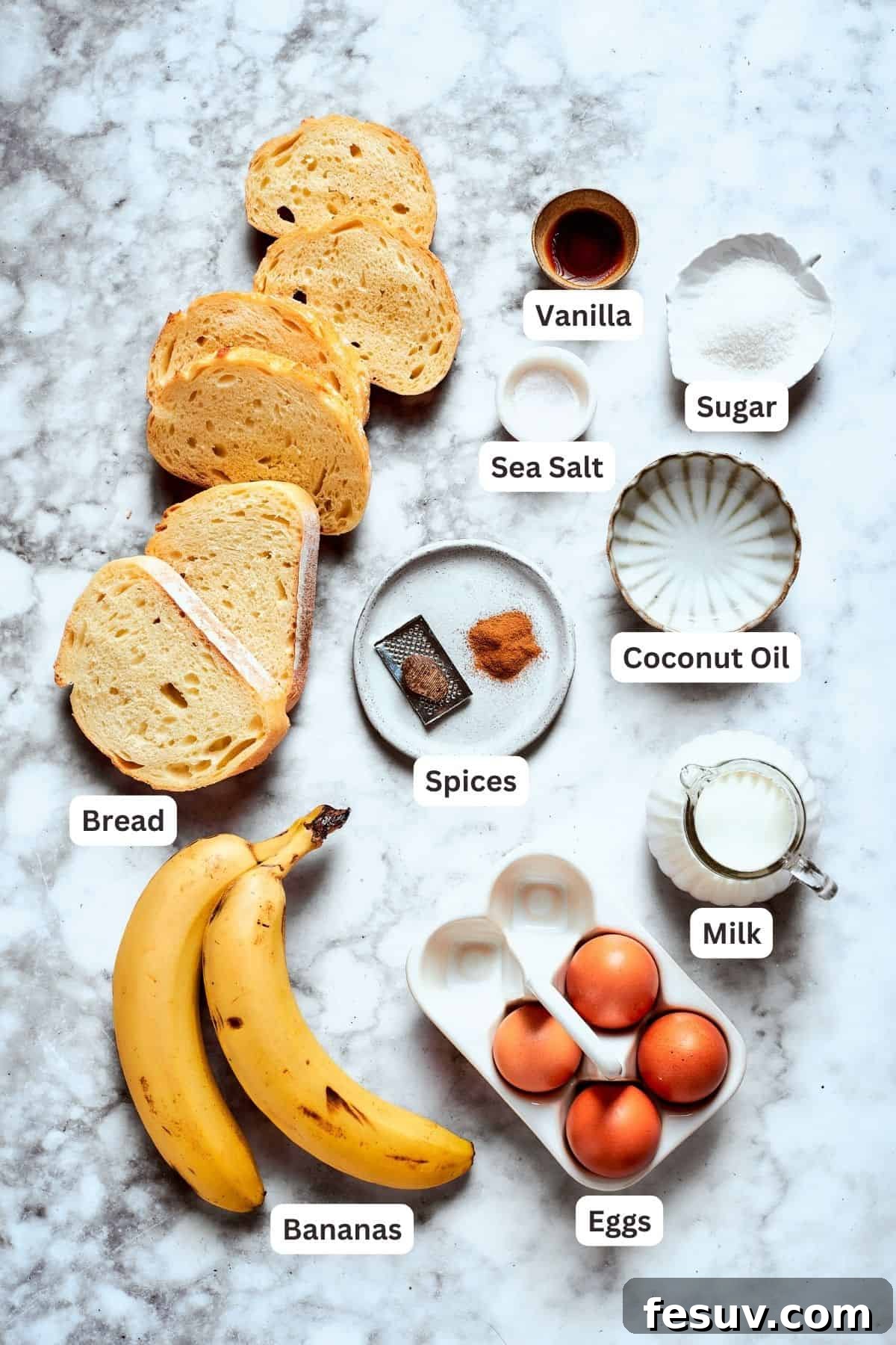 Fresh ingredients ready for preparing delicious Banana French Toast. All the fresh ingredients for banana French toast are displayed, including ripe bananas, thick slices of bread, aromatic cinnamon, nutmeg, fresh eggs, milk, coconut oil, a pinch of salt, sugar, and pure vanilla extract.