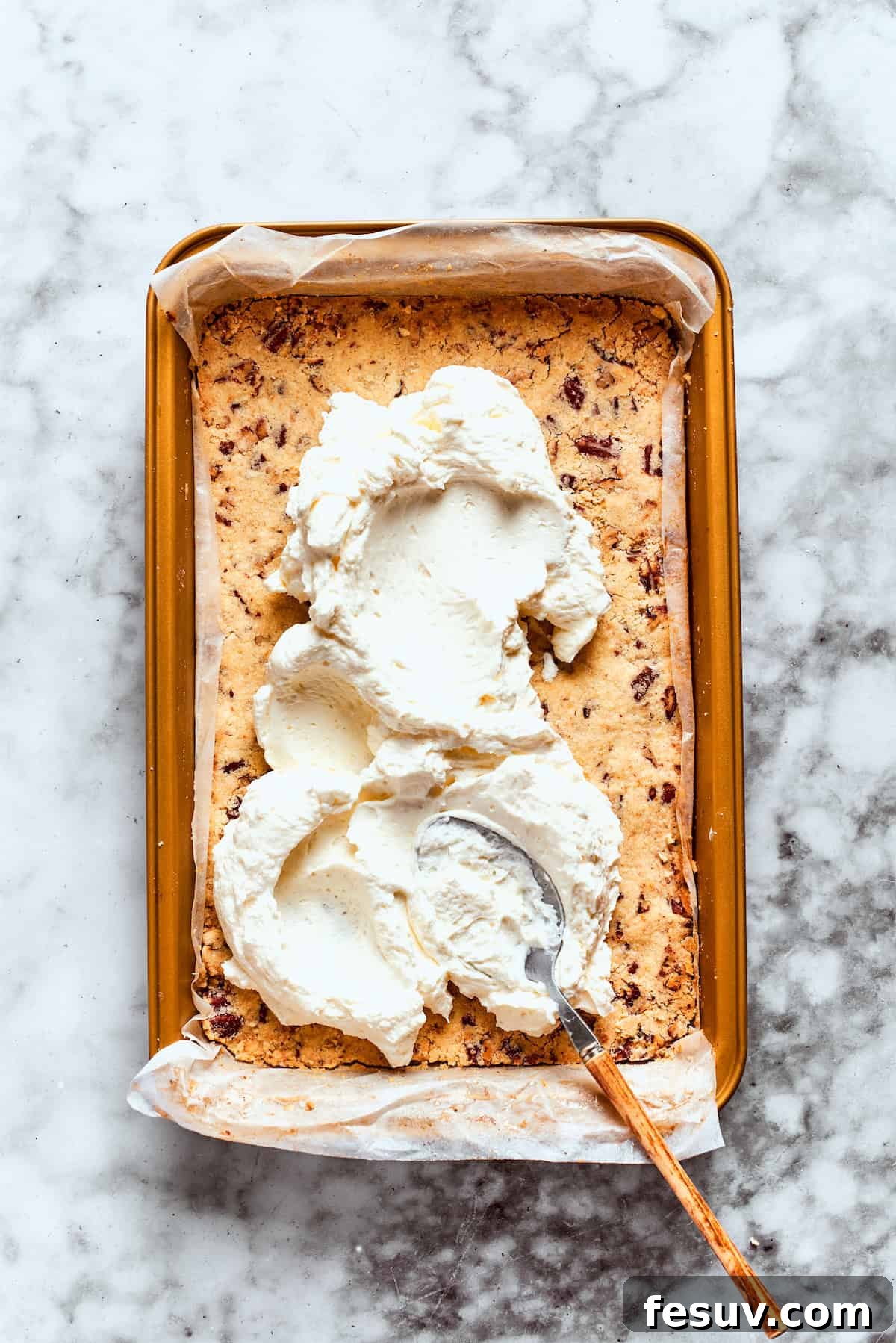 This easy Sex in a Pan recipe layers a tangy-sweet cream cheese filling with vanilla and chocolate puddings on top of a pecan crust. The cream cheese layer is added to the cooled pecan crust.
