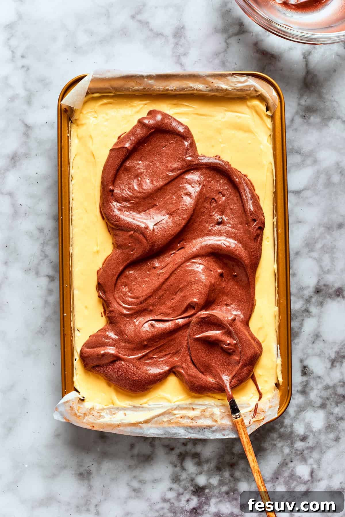 This easy Sex in a Pan recipe layers a tangy-sweet cream cheese filling with vanilla and chocolate puddings on top of a pecan crust. The chocolate pudding layer is added over the vanilla pudding.