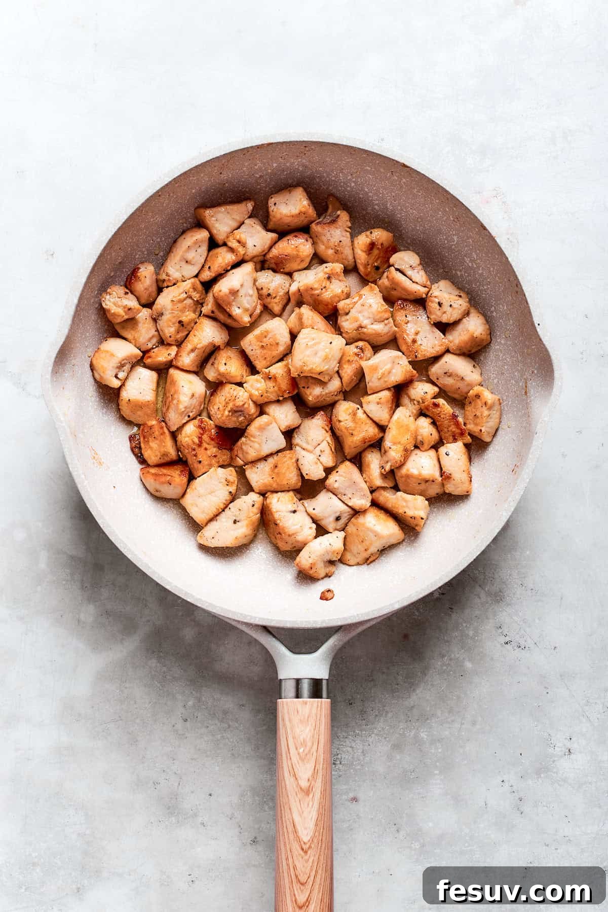 Chicken pieces are browned in a skillet for teriyaki chicken recipe.